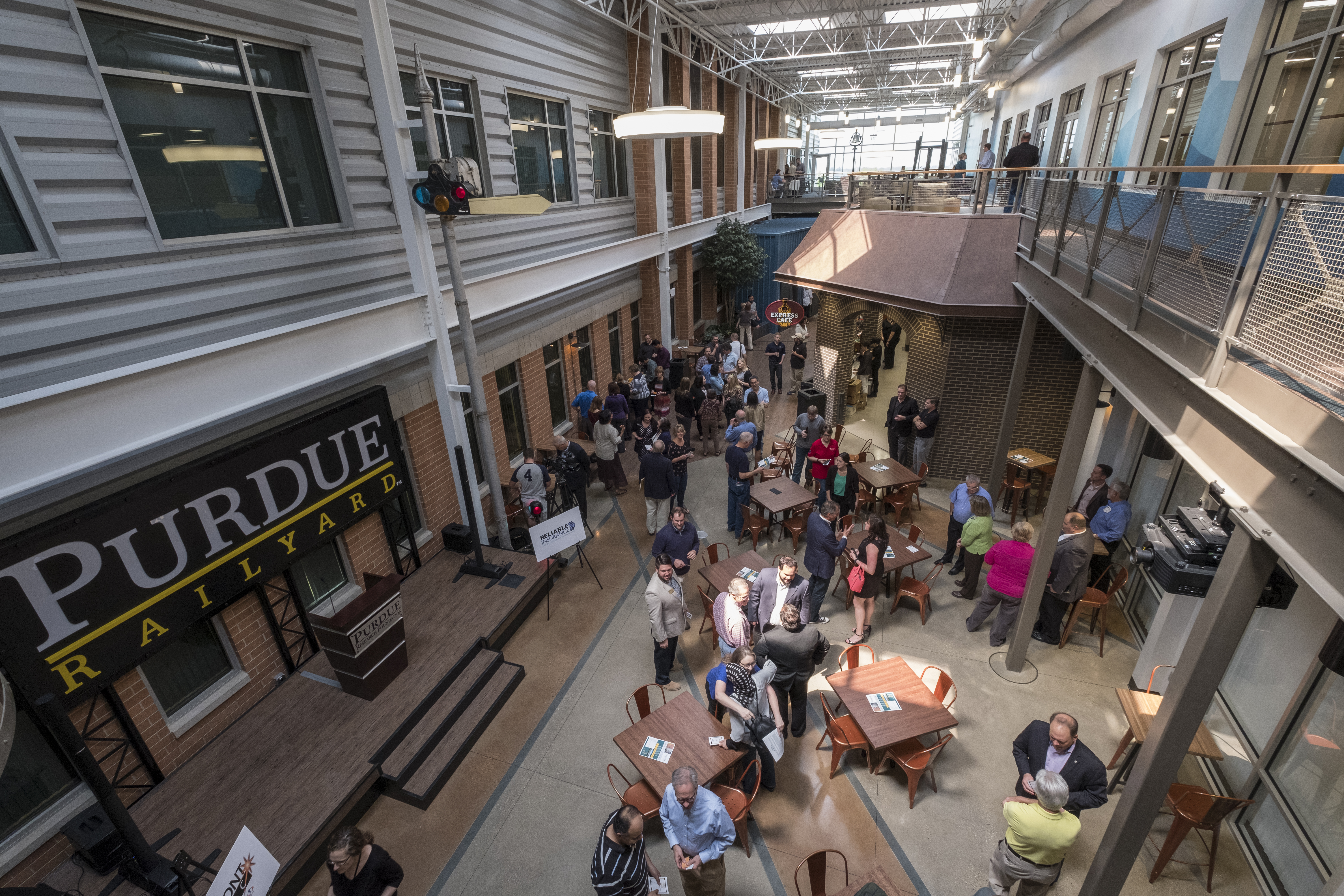 Overhead view of Purdue Railyard common area with several people sitting at tables